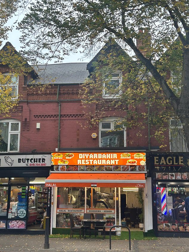 A south Asian restaurant sits next door to a halal butchers and a Turkish barbers