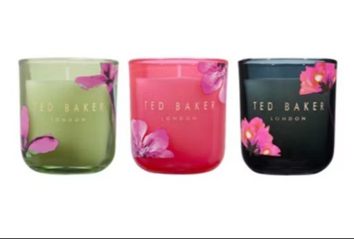 Three Ted Baker London scented candles in green, pink, and black glass jars with floral designs.
