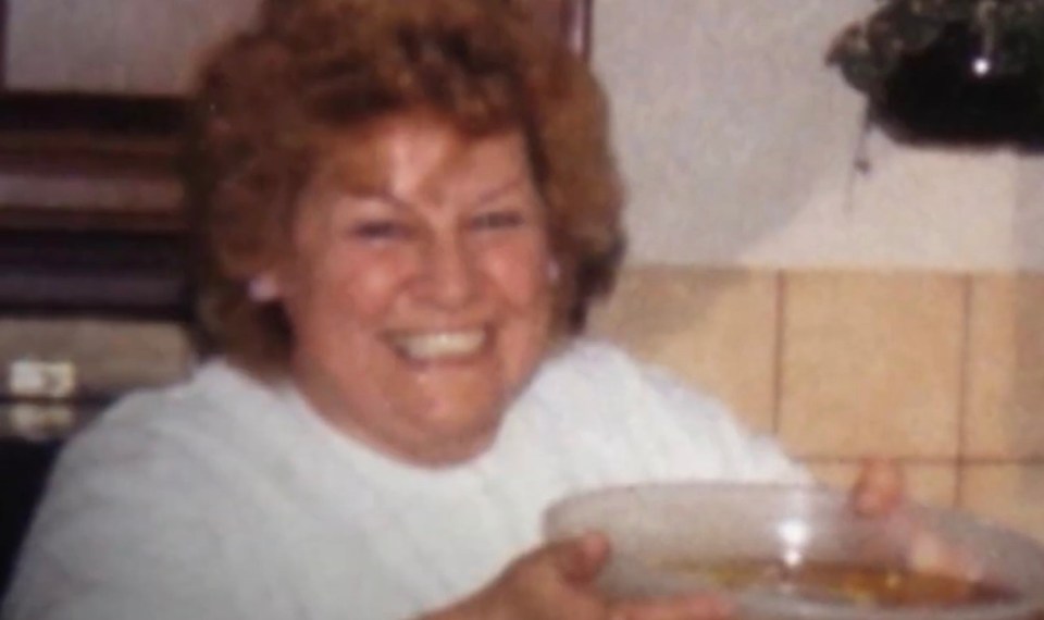 A video of a smiling woman with curly hair holding a bowl, with the caption "murdered in her own home, which is not the norm."