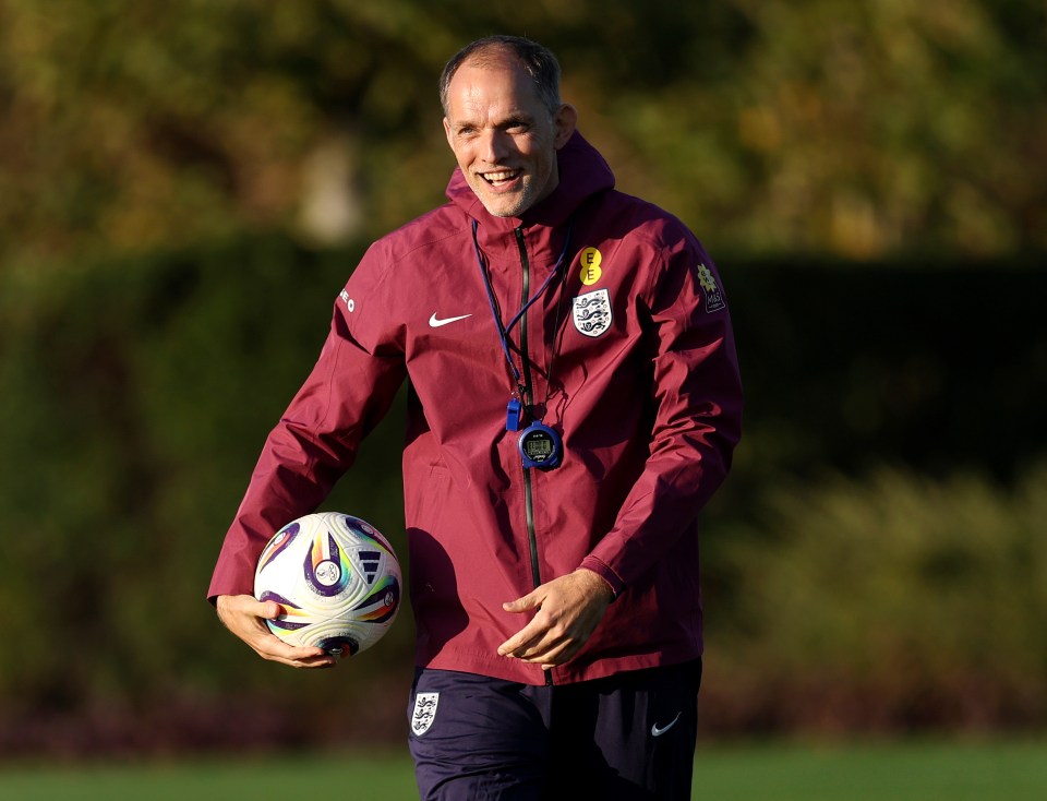 Thomas Tuchel, Head Coach of England, smiles while holding a soccer ball.