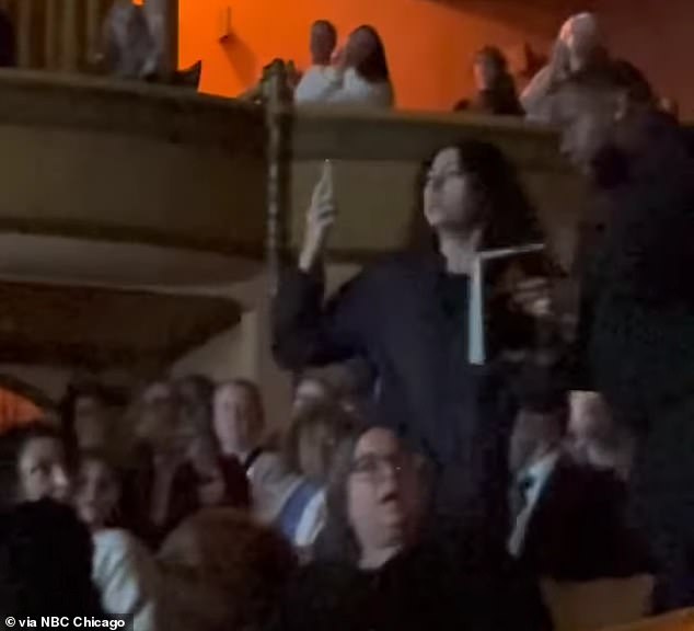 Harris, 60, was discussing her book with journalist Michele Norris when one woman from the audience began yelling while filming on her phone, as shown in the screenshot above