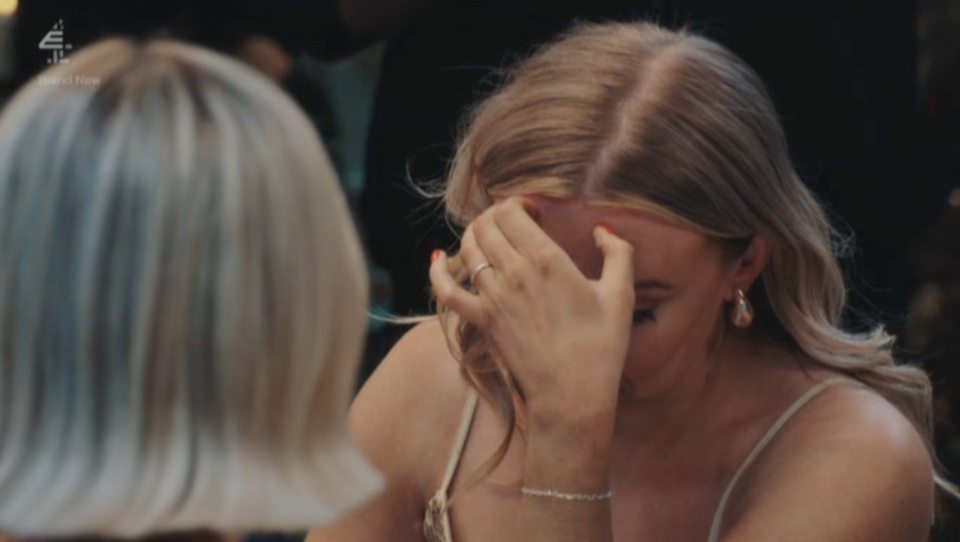 MAFS bride Sarah cries with her head in her hands at a dinner party.