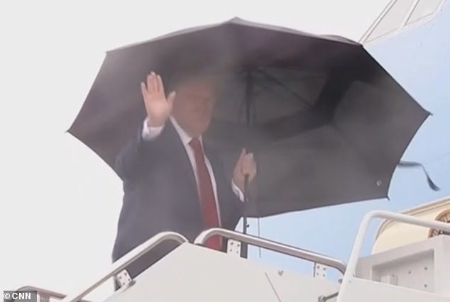 The President waves as he boards the aircraft at Joint Base Andrews in Maryland