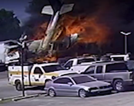 Illustration of a burning airplane crashed into a parking lot.