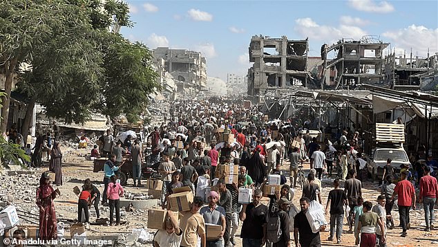 A large crowd gathers for first aid trucks in Gaza on October 12 amid the ceasefire