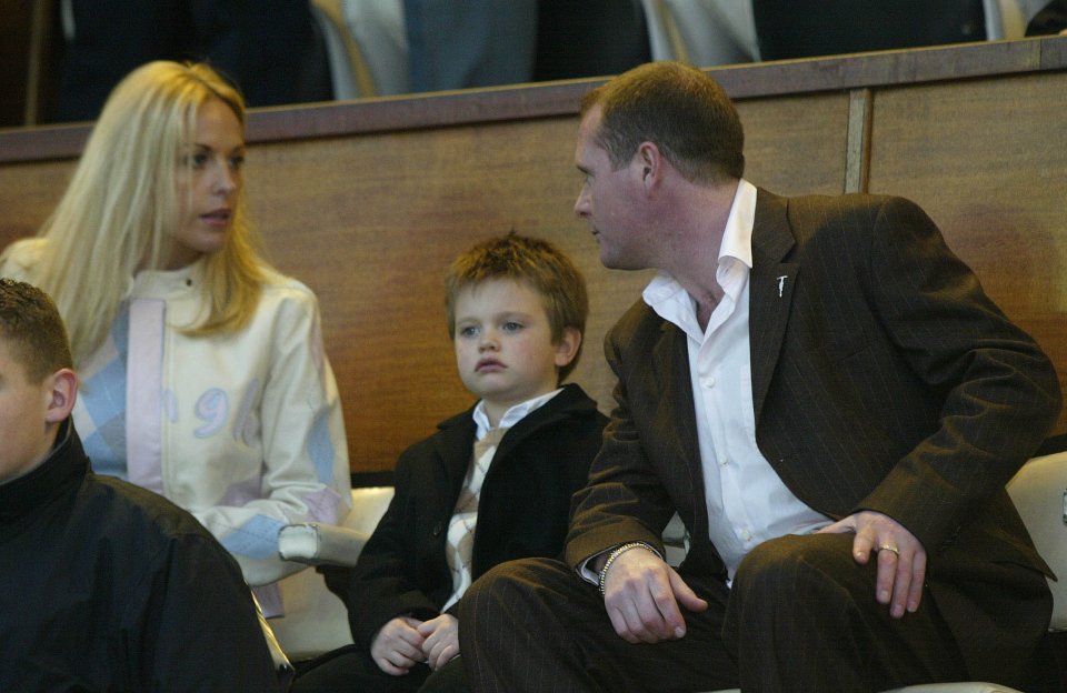 Paul Gascoigne, Sheryl Gascoigne, and their son Reagan sit in a stadium.