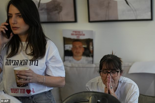 Family and friends of Israeli hostage Bar Kuperstein react as they watch the live broadcast of hostages being released from Hamas captivity in Gaza, in Holon, Israel, Monday, Oct. 13, 2025. (AP Photo/Francisco Seco)