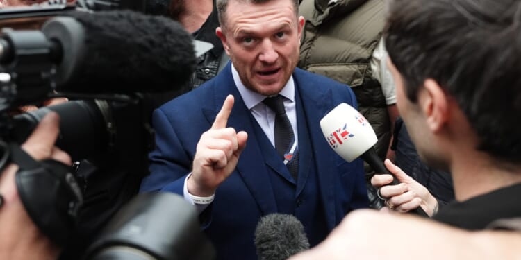 Tommy Robinson arrives at court for 'terror' trial after being stopped at Channel Tunnel by cops