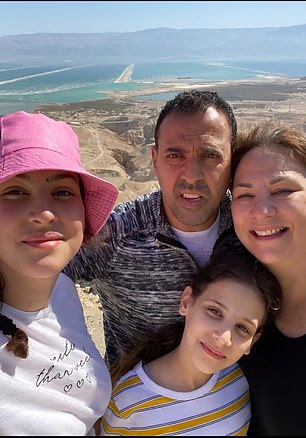 Eli Sharabi with his wife and daughters before they were killed