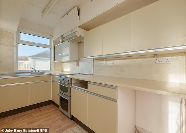 The kitchen as it stands follows a mild colour scheme. The property is being sold by John Bray Estates