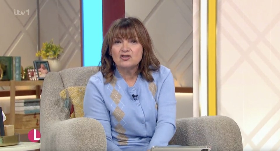 Lorraine Kelly speaking on the show, wearing a light blue argyle cardigan.