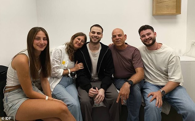 Released hostage Alon Ohel with his family at the IDF's Re'im base