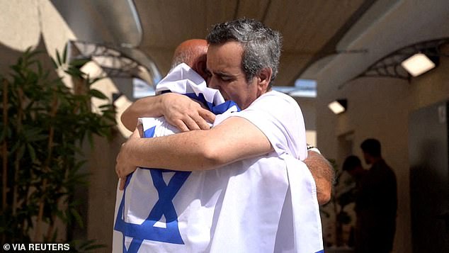 Released Israeli hostage, Omri Miran, held in Gaza since the deadly October 7, 2023 attack by Hamas, embraces his father, Dani Miran