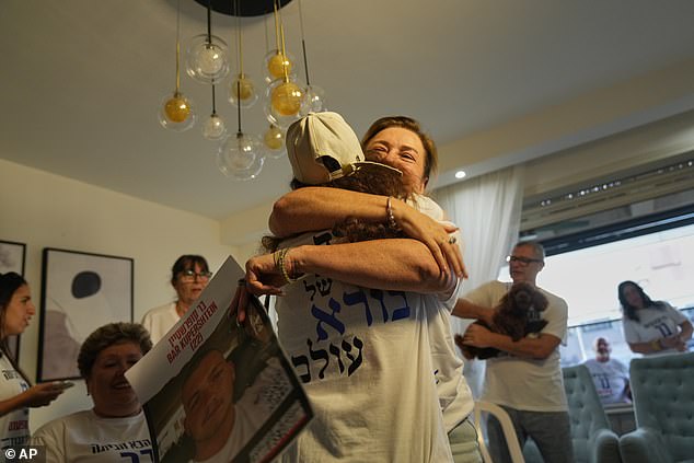 Ora Rubinstein, right, aunt of Israeli hostage Bar Kupershtein, hugs a friend as they wait with others for the release of hostages
