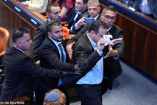 Security officials remove a Knesset member who interrupted President Donald Trump speech to the Knesset