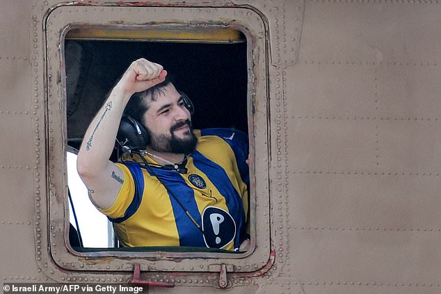 Ziv Berman gestures from the window of an Israeli CH-53 Sea Stallion military helicopter at Sheba Tel-HaShomer Medical Centre in Ramat Gan