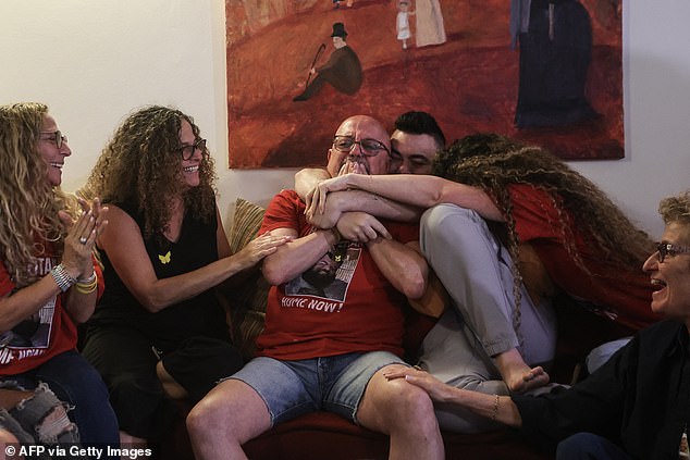 Family and friends of Israeli hostage Eitan Horn react to the news of his release at their house in the central Israeli city of Rosh Haayin