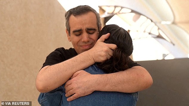 Released Israeli hostage, Omri Miran, held in Gaza since the deadly October 7, 2023 attack by Hamas, embraces his wife, Lishay Miran-Lav, after being released as part of a prisoner-hostage swap and a ceasefire deal between Israel and Hamas, in Reim, Israel October 13, 2025