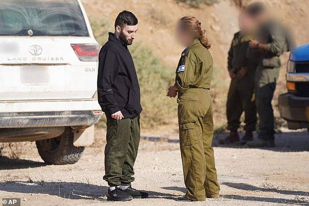 In this photo provided by the Israeli Defense Forces, Matan Angrest speaks with an IDF representative in Israel on Monday, Oct. 13, 2025