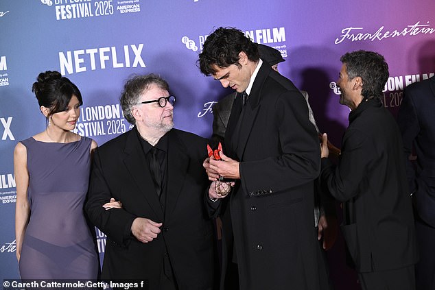 The acclaimed filmmaker displayed his fondness for dark fantasy by accessorising with a red winged figurine on a chain