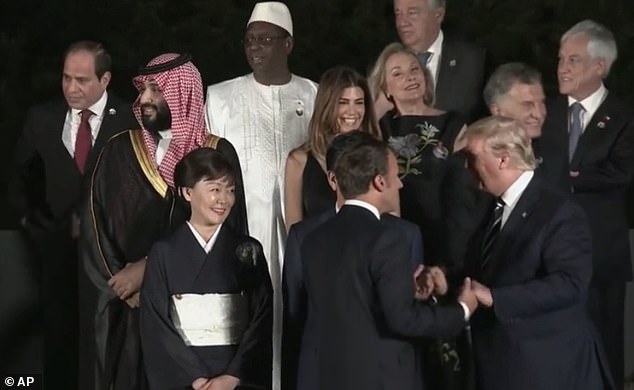 Trump and Macron pictured above during another long handshake in June 2019