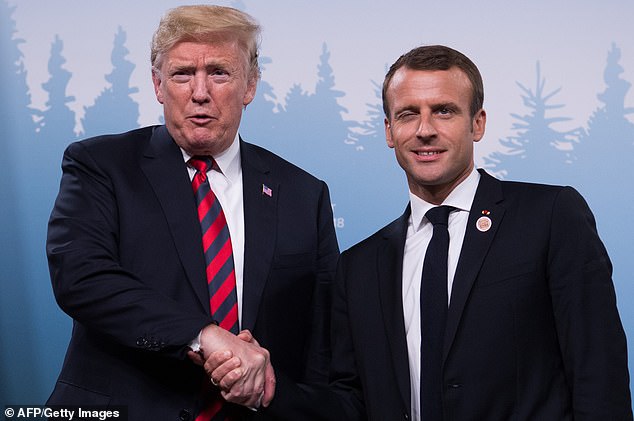 Trump and Macron clinch hands as they meet on the sidelines of the G7 in Quebec, Canada in June 2018
