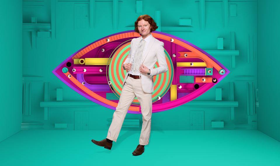 George, a Big Brother contestant, posing in front of the show's eye logo.