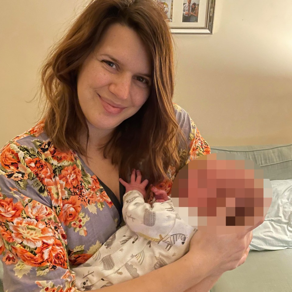 Jennifer Cahill holding her infant.