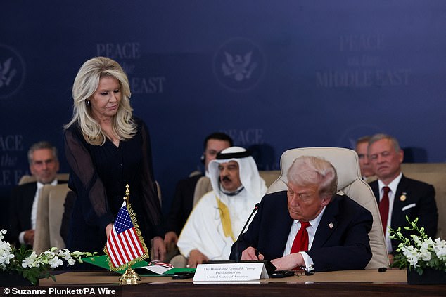 US President Donald Trump signs the agreement during the Sharm El Sheikh Peace Summit in Egypt