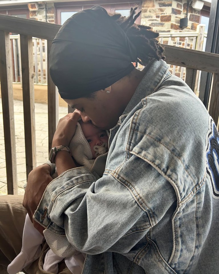 Person kissing a baby.