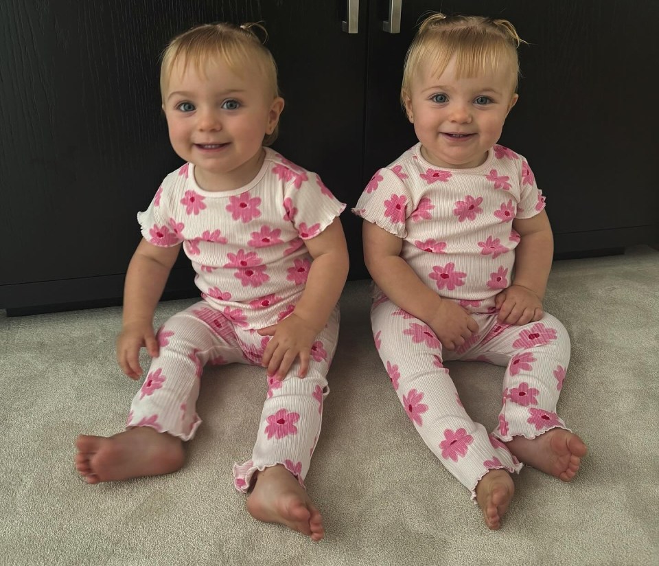 Two young girls, daughters of Dani Dyer, in matching floral outfits.