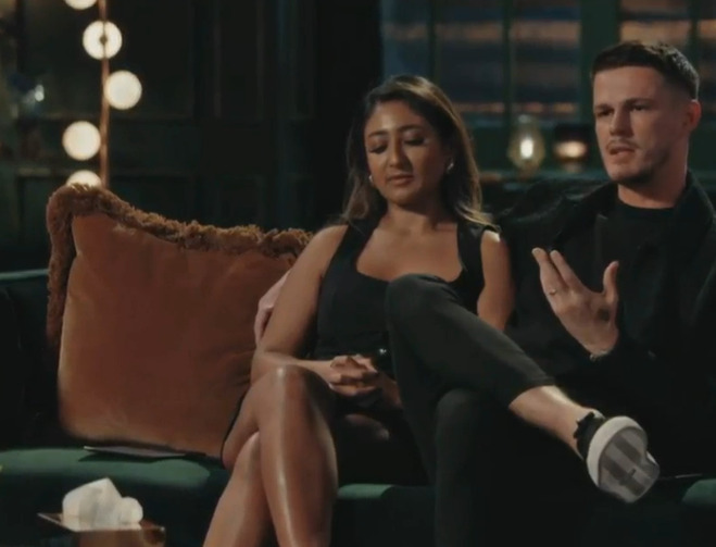 Steven and a woman sitting on a couch.