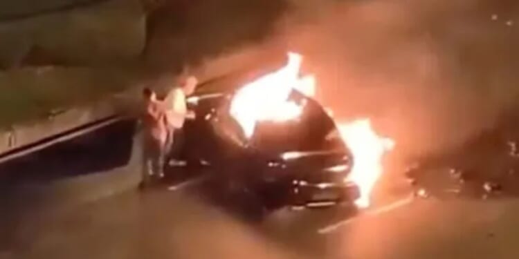 Driver burns alive trapped in electric car as doors lock shut with bystanders unable to get him out after fiery crash