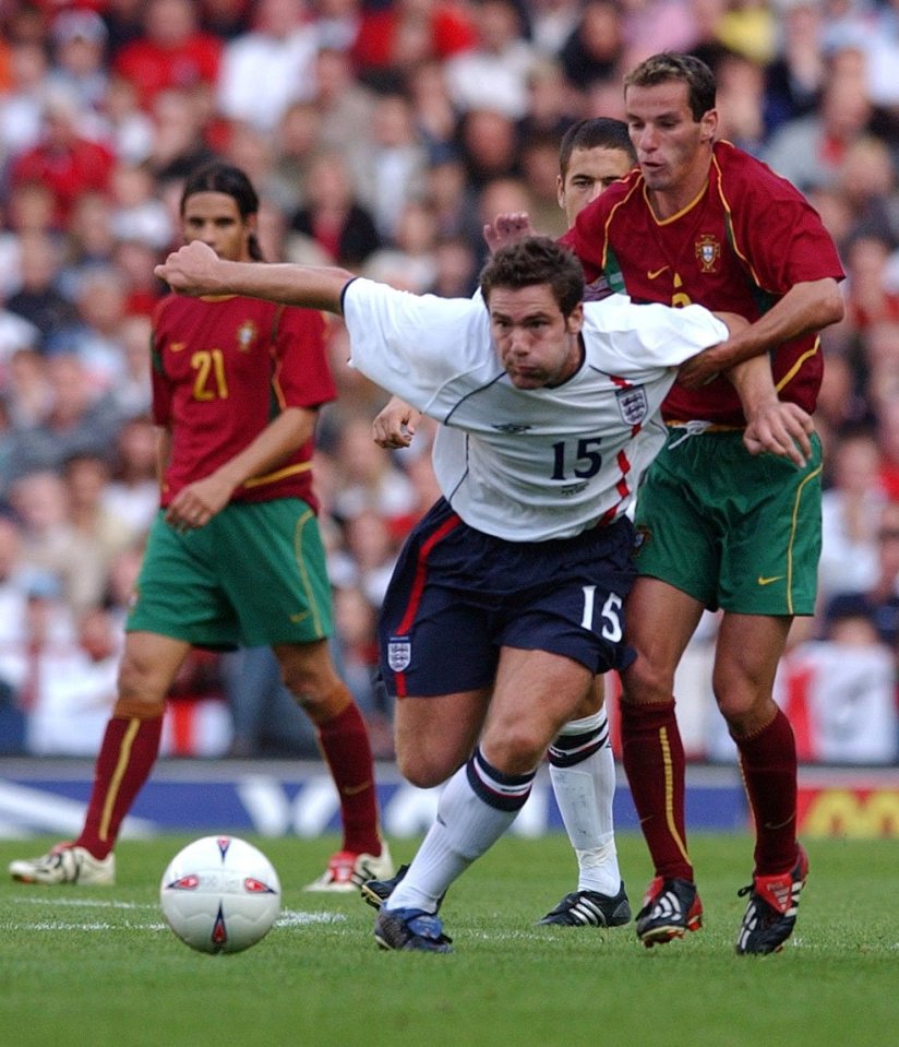 England's Wayne Bridge (front) holds off Portugal's Armando Teixeira.