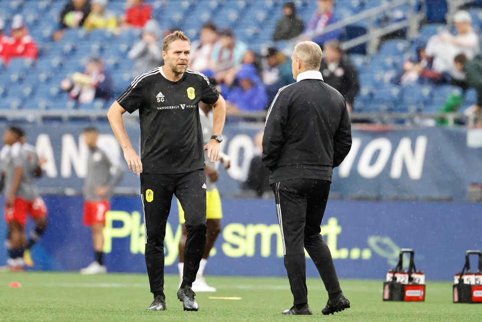 Nashville SC assistant coach Steve Guppy chats with Nashville SC head coach Gary Smith before a match.