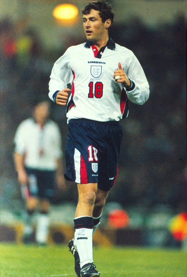 Chris Sutton of England, wearing a white jersey with the number 18, on the field during an international friendly football match against Cameroon.
