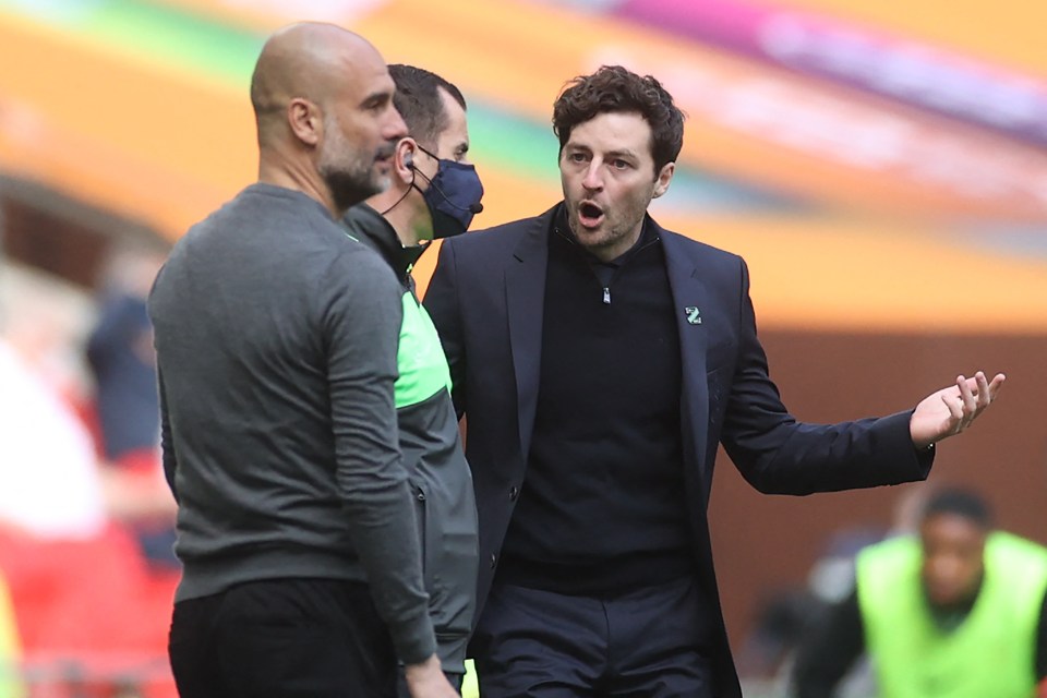 Manchester City manager Pep Guardiola talking to Tottenham Hotspur coach Ryan Mason.