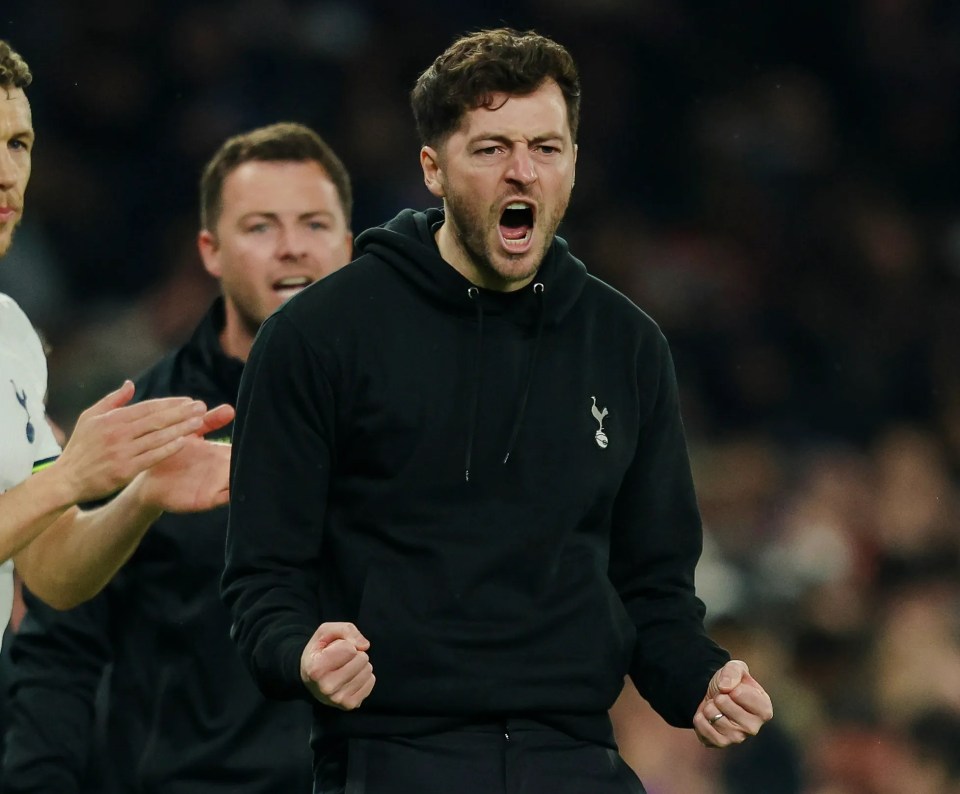 Tottenham head coach Ryan Mason celebrates with clenched fists and an open mouth.