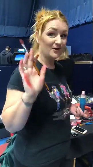 Body painter Kae Burnell Chambers with paint on her hand.