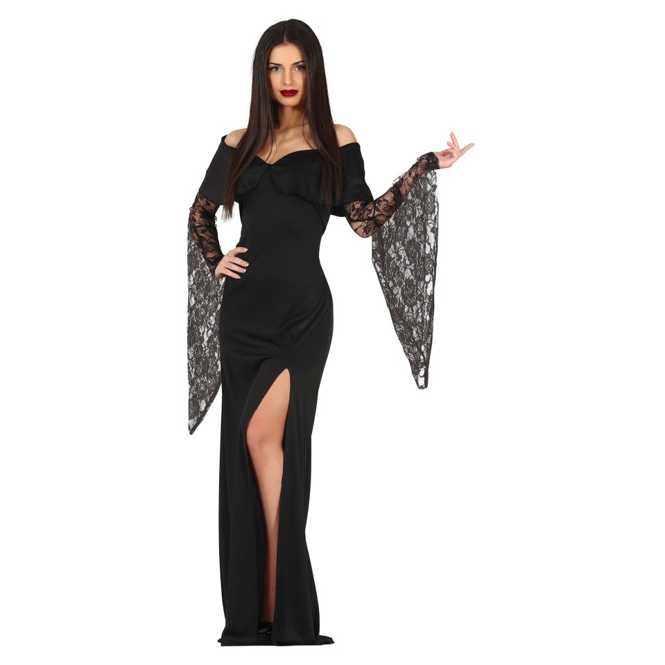 A woman with long dark hair, dark lipstick, and a black off-the-shoulder dress with a thigh-high slit and bell sleeves made of lace, stands facing the camera, with her left hand on her hip and right hand raised.