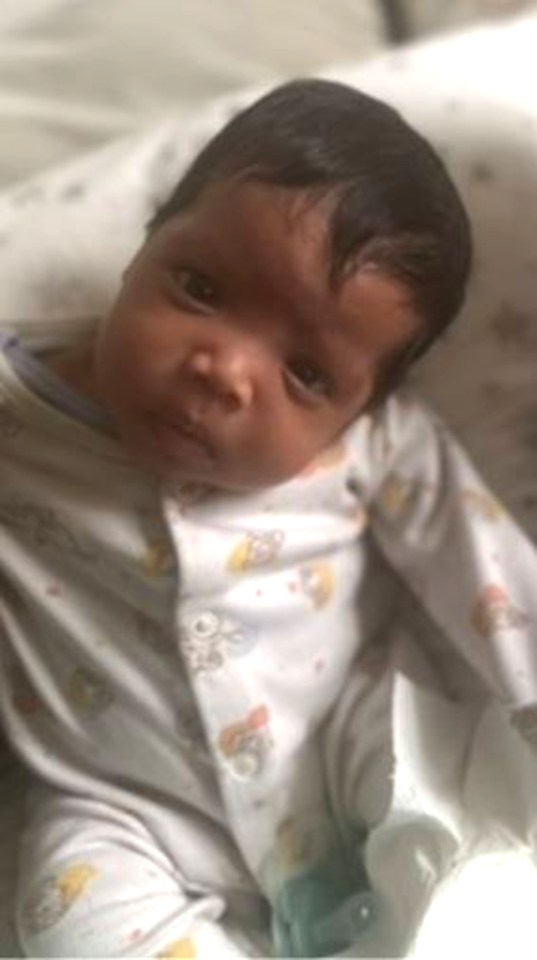 Kaylani Kalanzi as a baby, wearing a white onesie with colorful cartoon animals.