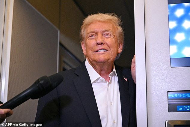 Trump speaks with the press on board Air Force One at RAF Mildenhall in England in the early hours of Tuesday