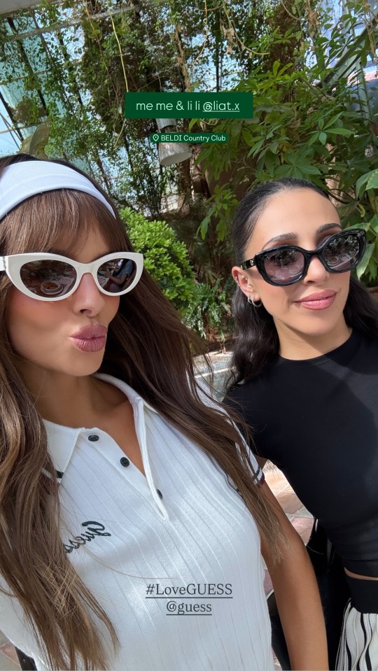 Maura Higgins and a friend posing in sunglasses during a Guess brand trip.