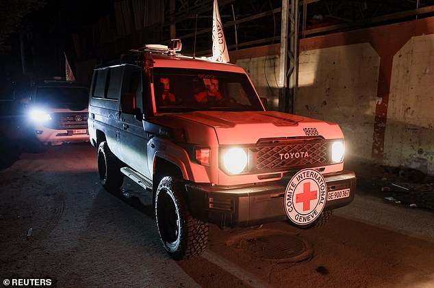 Red Cross vehicles arrive to receive from Hamas militants bodies of deceased hostages who had been held in Gaza since the deadly October 7, 2023 attack
