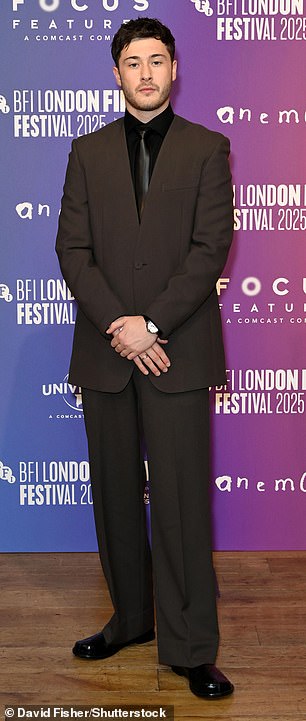 Samuel Bottomley sported a brown suit with a black shirt and tie