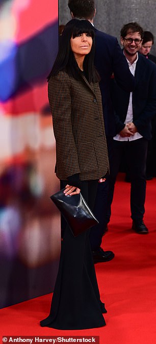 Claudia Winkleman opted for a brown jacket with flared trousers