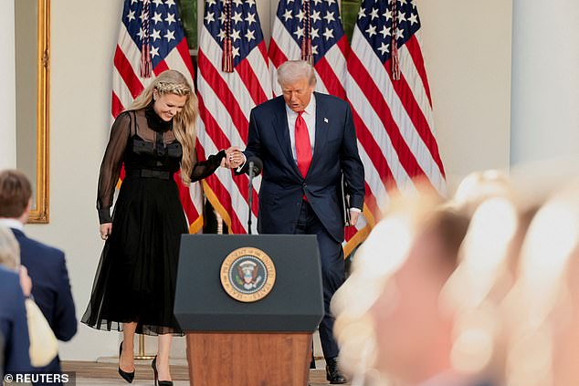 U.S. President Donald Trump walks with Erika Kirk, wife of slain conservative commentator Charlie Kirk