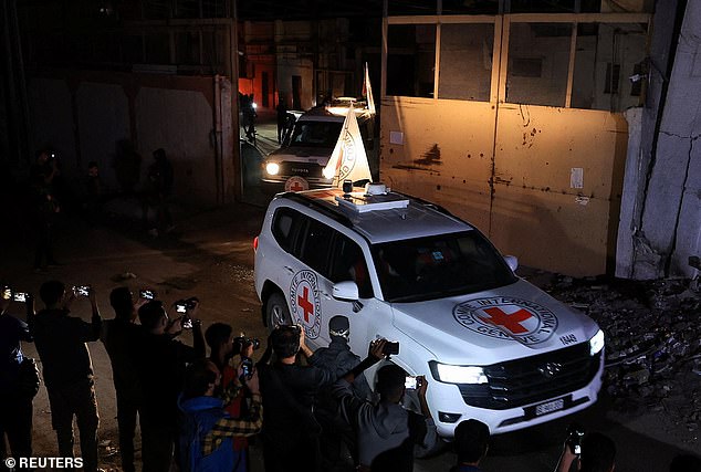 Red Cross vehicles transport the bodies of deceased hostages who had been held in Gaza since the deadly October 7, 2023 attack, after they were handed over by Hamas militants as part of a ceasefire and a hostages-prisoners swap deal between Hamas and Israel, in Gaza City, October 14, 2025