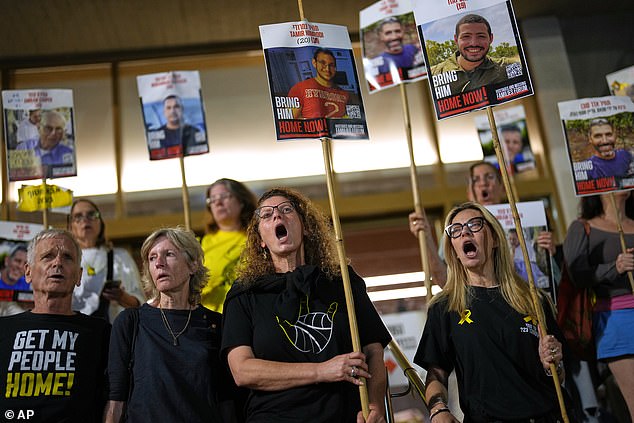 Relatives of hostages whose bodies are still in Gaza Strip shout slogans calling for their release at the plaza known as hostages square, in Tel Aviv, Israel, Tuesday, October 14, 2025