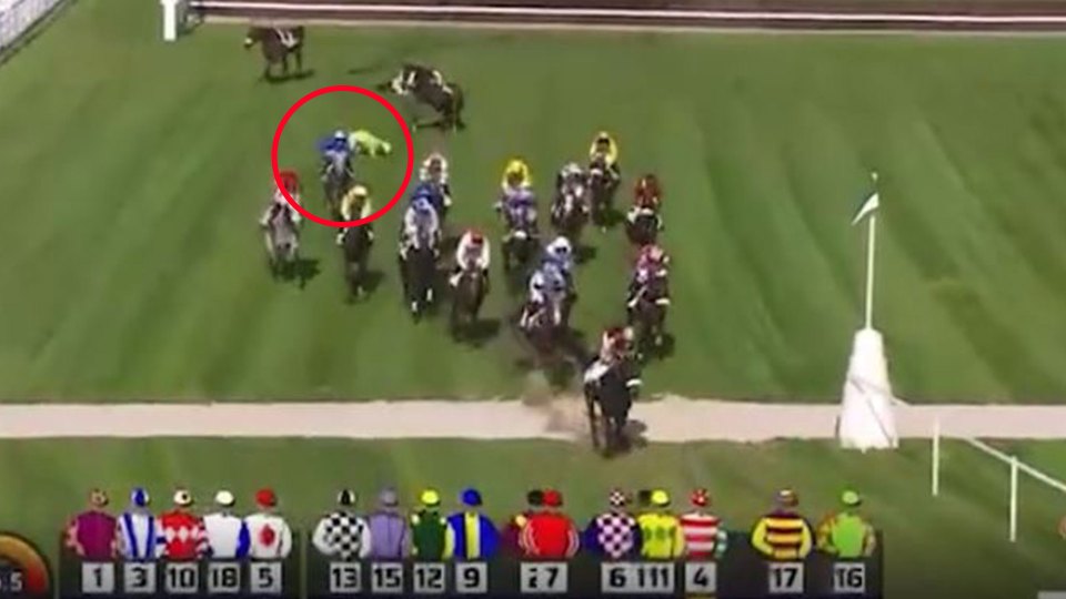 A jockey fallen from a horse at a race.